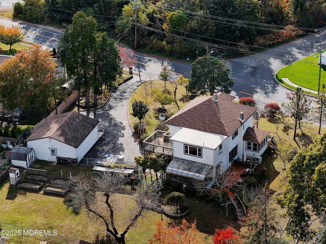 an aerial view of a house with a yard and lake view