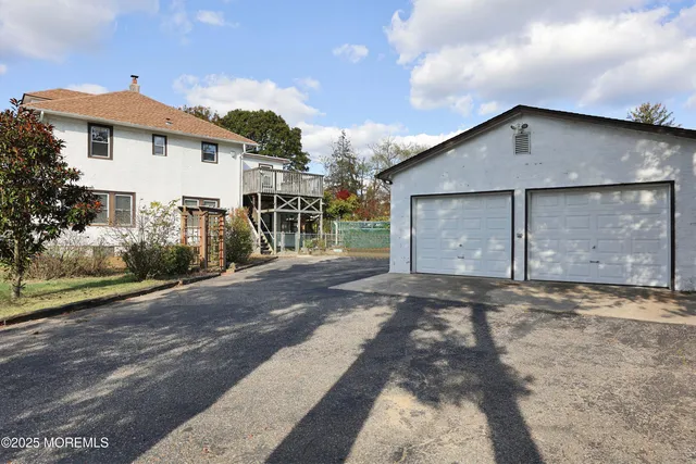 a view of a house with a yard and garage