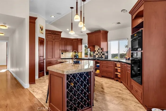 a bedroom with a bed a couch and a chandelier