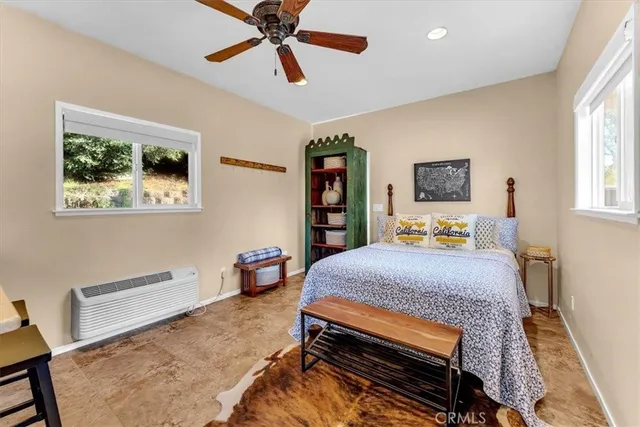 a bathroom with a toilet and a potted plant