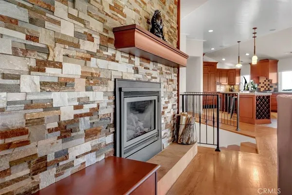 a kitchen with stainless steel appliances granite countertop a table chairs sink and microwave