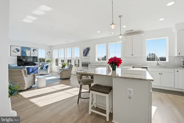 a kitchen with stainless steel appliances kitchen island granite countertop a sink and cabinets