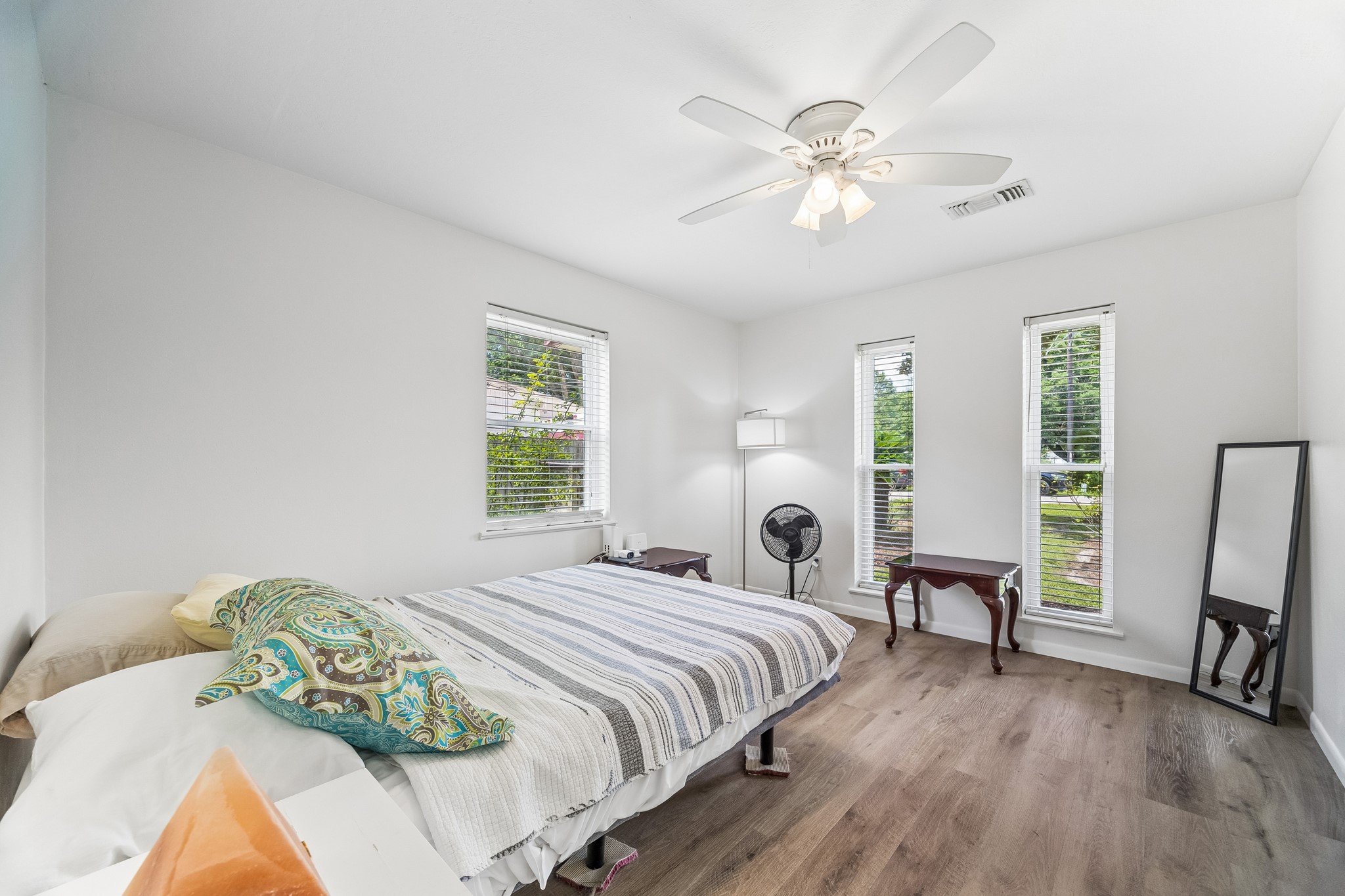 413 Mebane Lane Rosenberg, TX 77471 - Photo 22 of 30 This secondary bright bedroom features large windows, a ceiling fan, recent paint, and updated flooring.