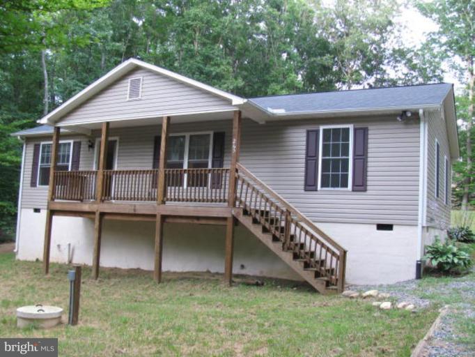 265 Cedar Ridge Drive Ruther Glen, VA 22546 - Photo 1 of 10 a front view of a house with a yard and balcony