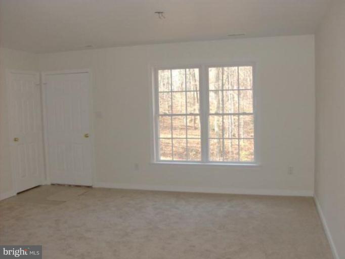 265 Cedar Ridge Drive Ruther Glen, VA 22546 - Photo 4 of 10 an empty room with a window