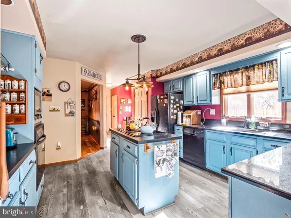 a kitchen with granite countertop a stove oven and a refrigerator