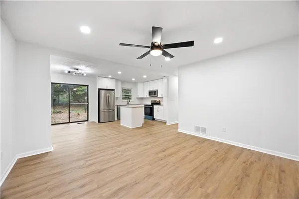 a view of a kitchen with a sink and a refrigerator