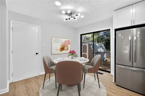 a dining room with furniture a livingroom view and wooden floor