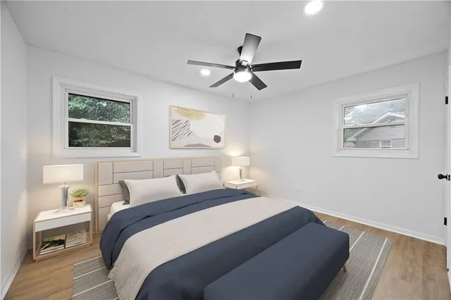 a bedroom with a bed and a painting on the wall