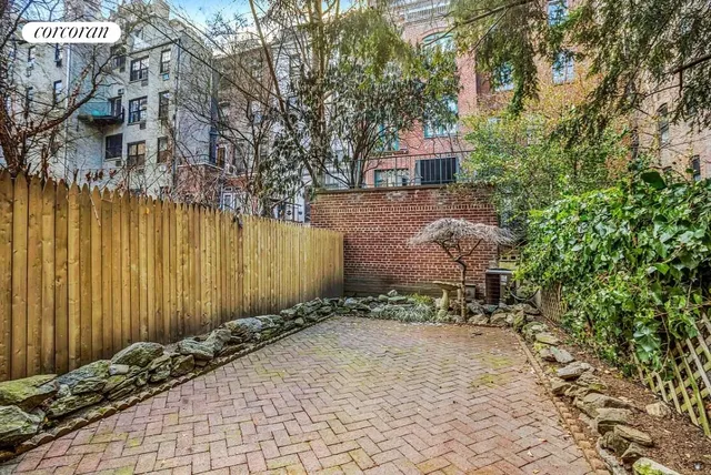 a view of a roof deck with couches and potted plants