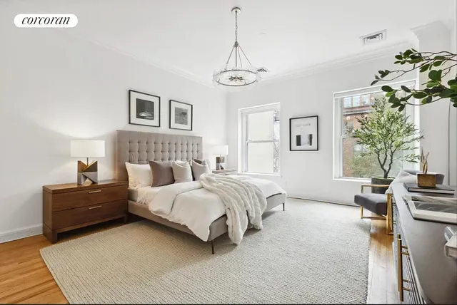 a bedroom with a large bed and a chandelier
