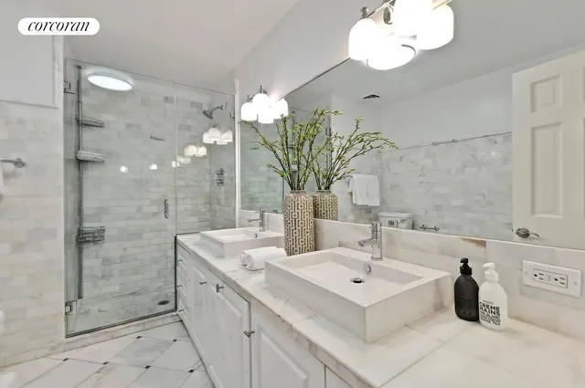 a spacious bedroom with a bed window and couch