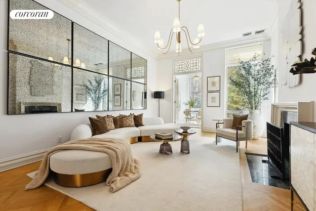 a living room with furniture and a chandelier