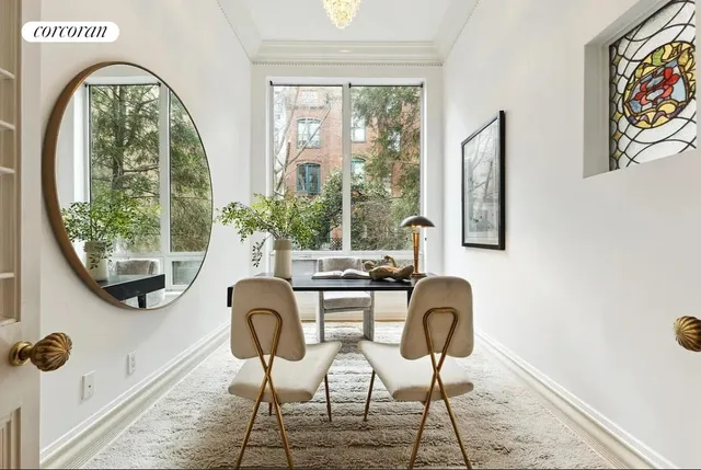 a living room with furniture chandelier and a large window