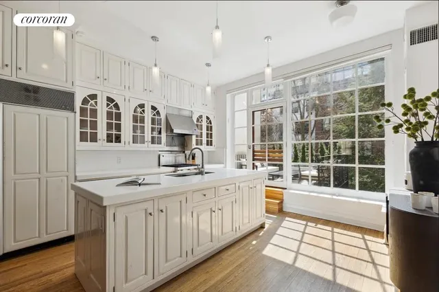 a dining room with furniture a chandelier and wooden floor