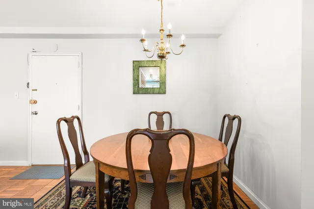 a view of a dining room with furniture and chandelier