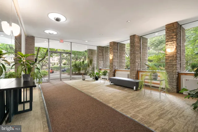 a lobby with furniture and large windows