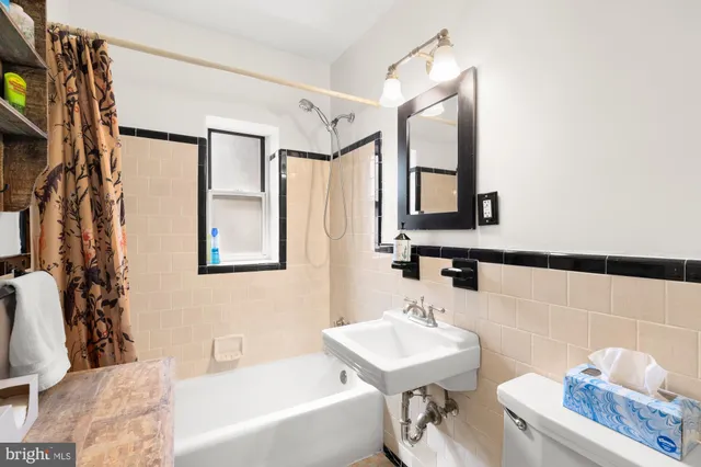 a bathroom with a sink mirror and a bathtub