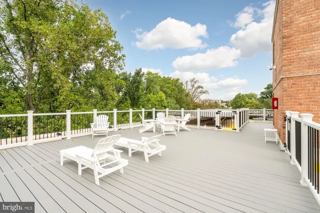 a view of a balcony with chairs and wooden floor