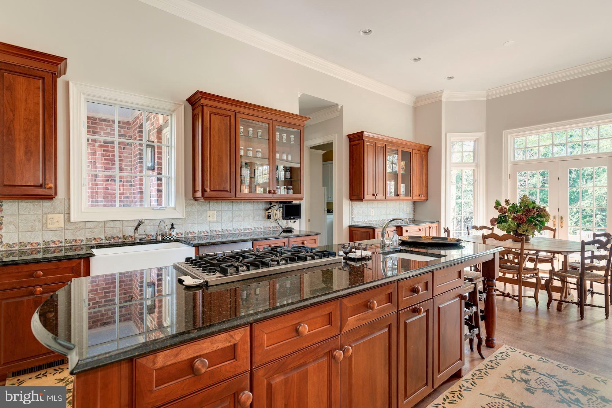 1099 Langley Fork Lane McLean, VA 22101 - Photo 11 of 33 a kitchen with stainless steel appliances granite countertop a stove a sink dishwasher and cabinets with wooden floor