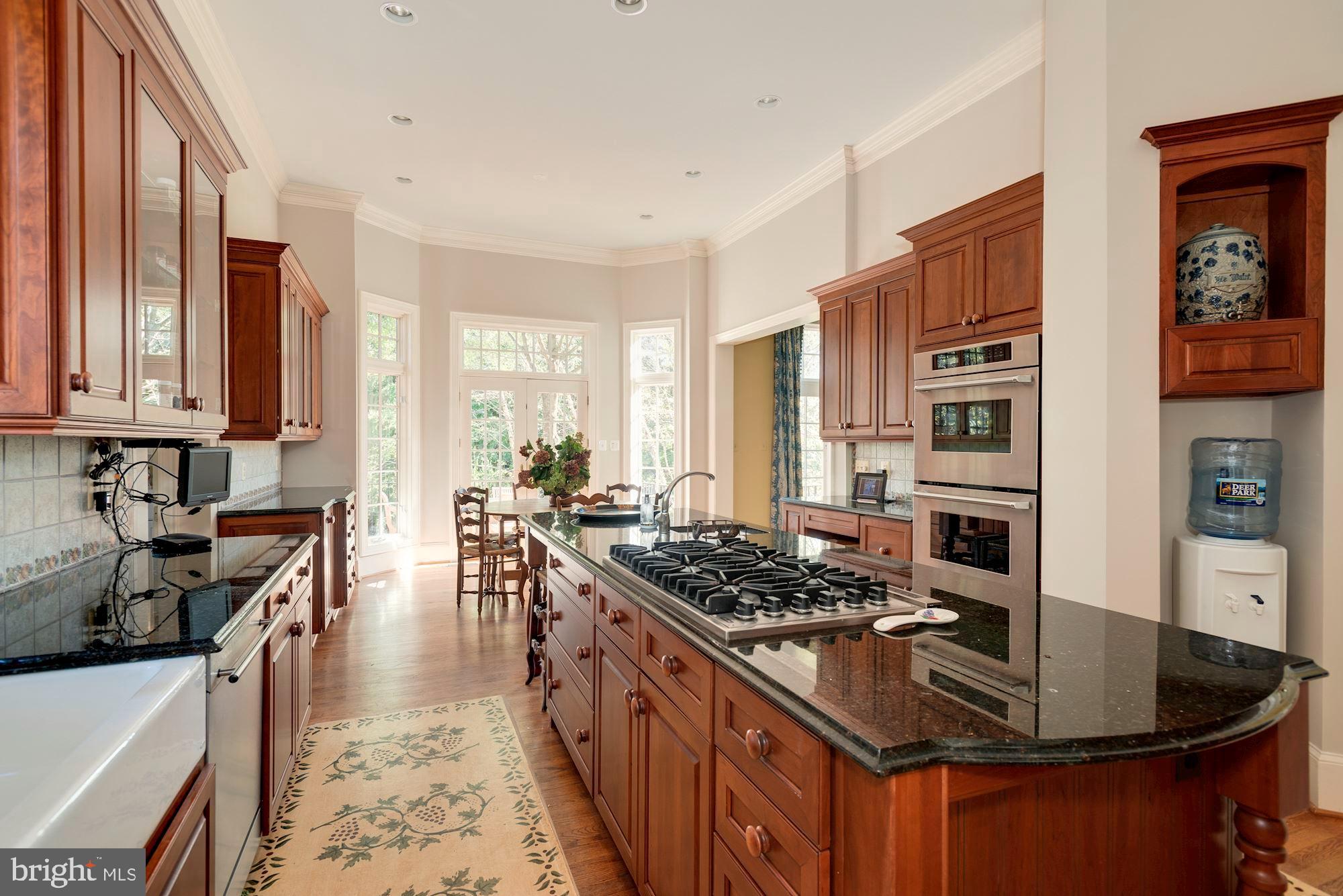 1099 Langley Fork Lane McLean, VA 22101 - Photo 12 of 33 a kitchen with stainless steel appliances granite countertop a stove a sink dishwasher and cabinets with wooden floor