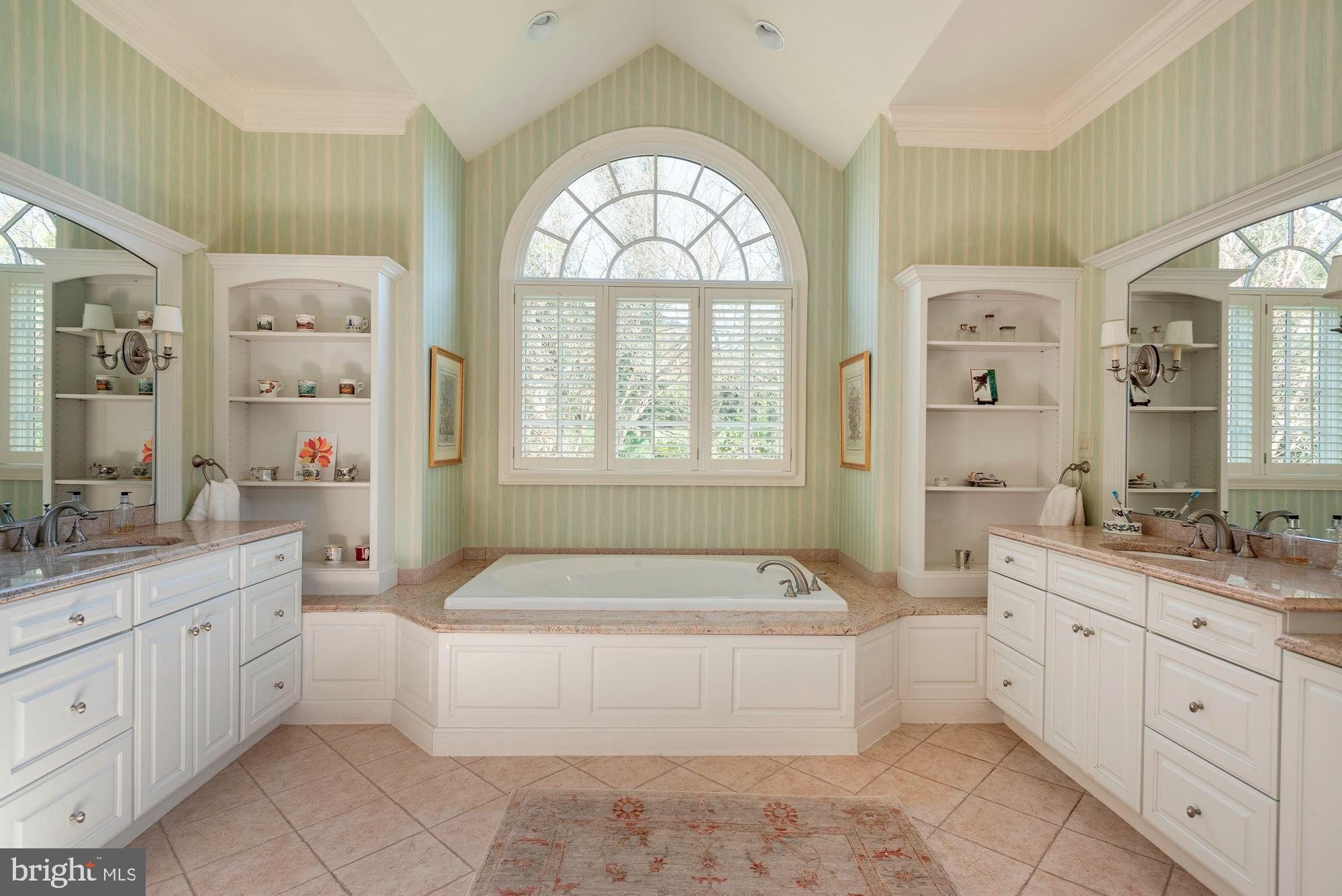 1099 Langley Fork Lane McLean, VA 22101 - Photo 21 of 33 a spacious bathroom with a granite countertop tub sink a mirror a window and a shower