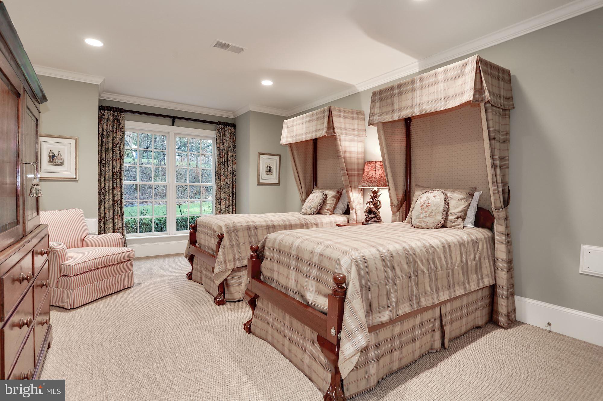 1099 Langley Fork Lane McLean, VA 22101 - Photo 30 of 33 a bedroom with a bed couch and a large window