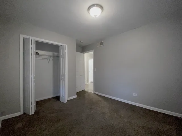 an empty room with closet area
