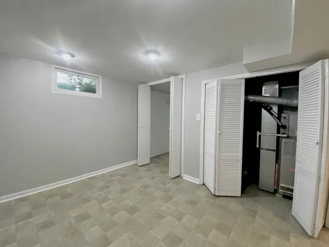 an empty room with closet and windows