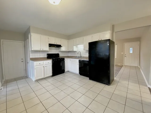 a kitchen with a cabinets and steel appliances