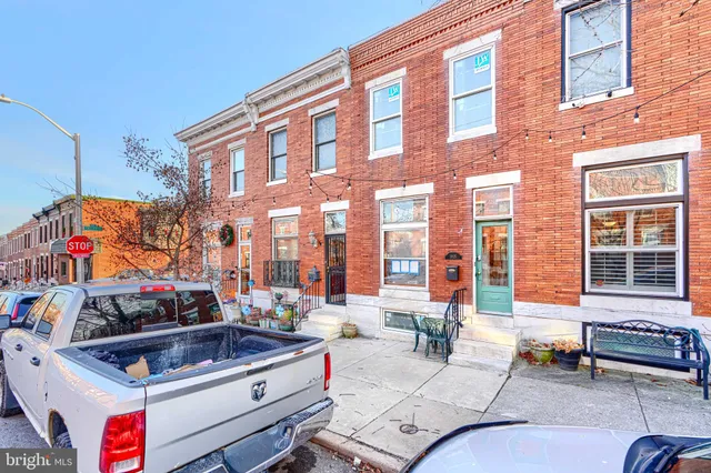 a building outdoor space with patio furniture and potted plants
