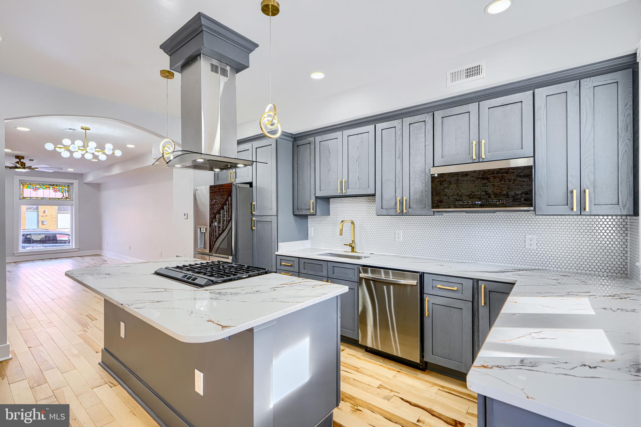 3825 Foster Avenue Baltimore, MD 21224 - Photo 15 of 54 a kitchen with a sink a microwave a stove and refrigerator