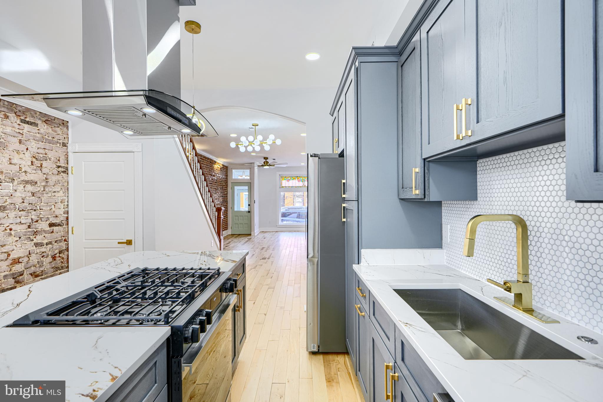 3825 Foster Avenue Baltimore, MD 21224 - Photo 16 of 54 a kitchen with stainless steel appliances granite countertop a sink stove and refrigerator