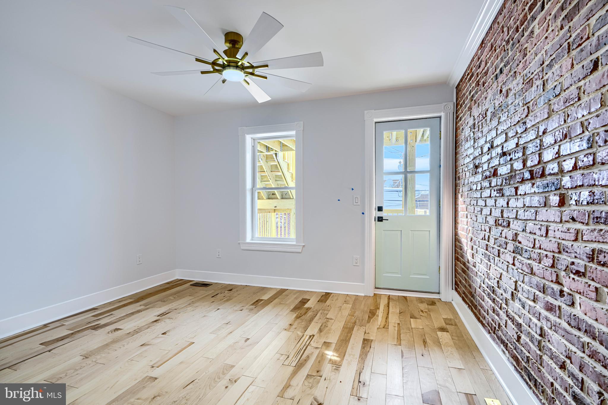 3825 Foster Avenue Baltimore, MD 21224 - Photo 28 of 54 wooden floor in an empty room with a window
