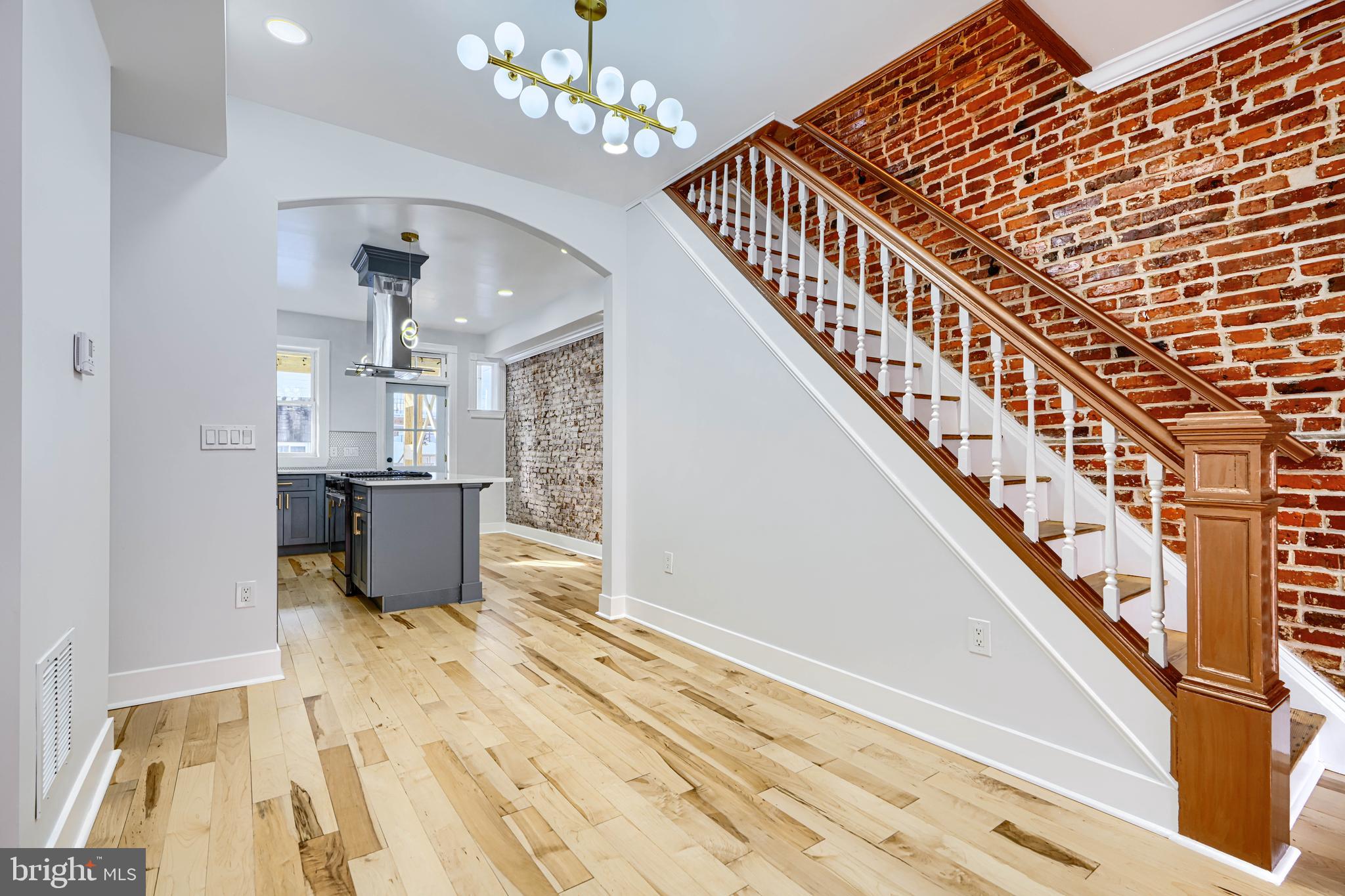 3825 Foster Avenue Baltimore, MD 21224 - Photo 3 of 54 a view of a livingroom with wooden floor and stairs