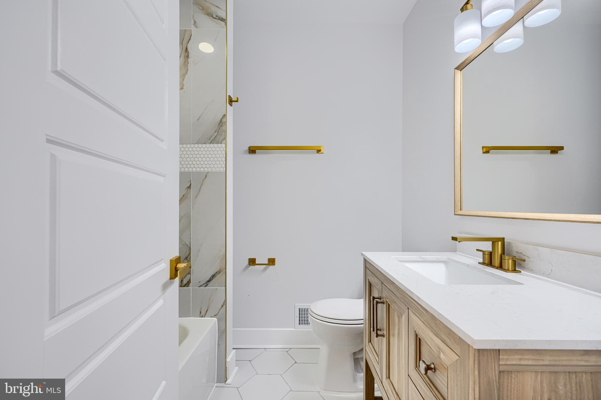 3825 Foster Avenue Baltimore, MD 21224 - Photo 31 of 54 a bathroom with a sink a toilet and shower
