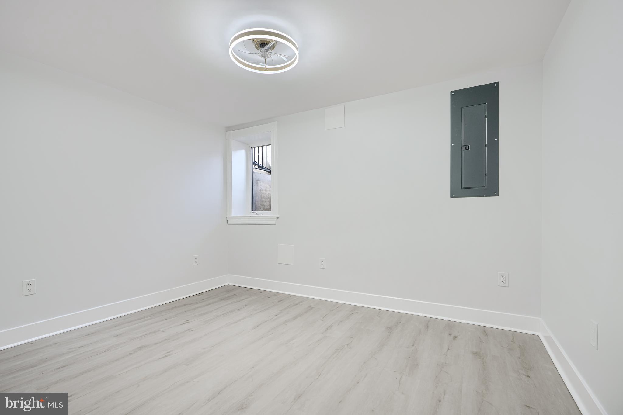 3825 Foster Avenue Baltimore, MD 21224 - Photo 38 of 54 an empty room with a window and a fan
