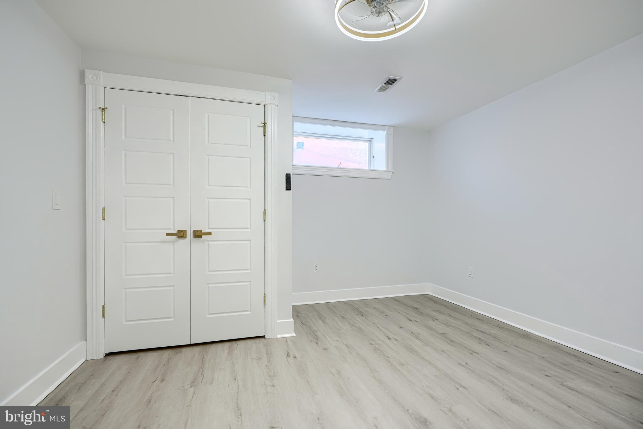 3825 Foster Avenue Baltimore, MD 21224 - Photo 41 of 54 a view of an empty room with wooden floor and a window