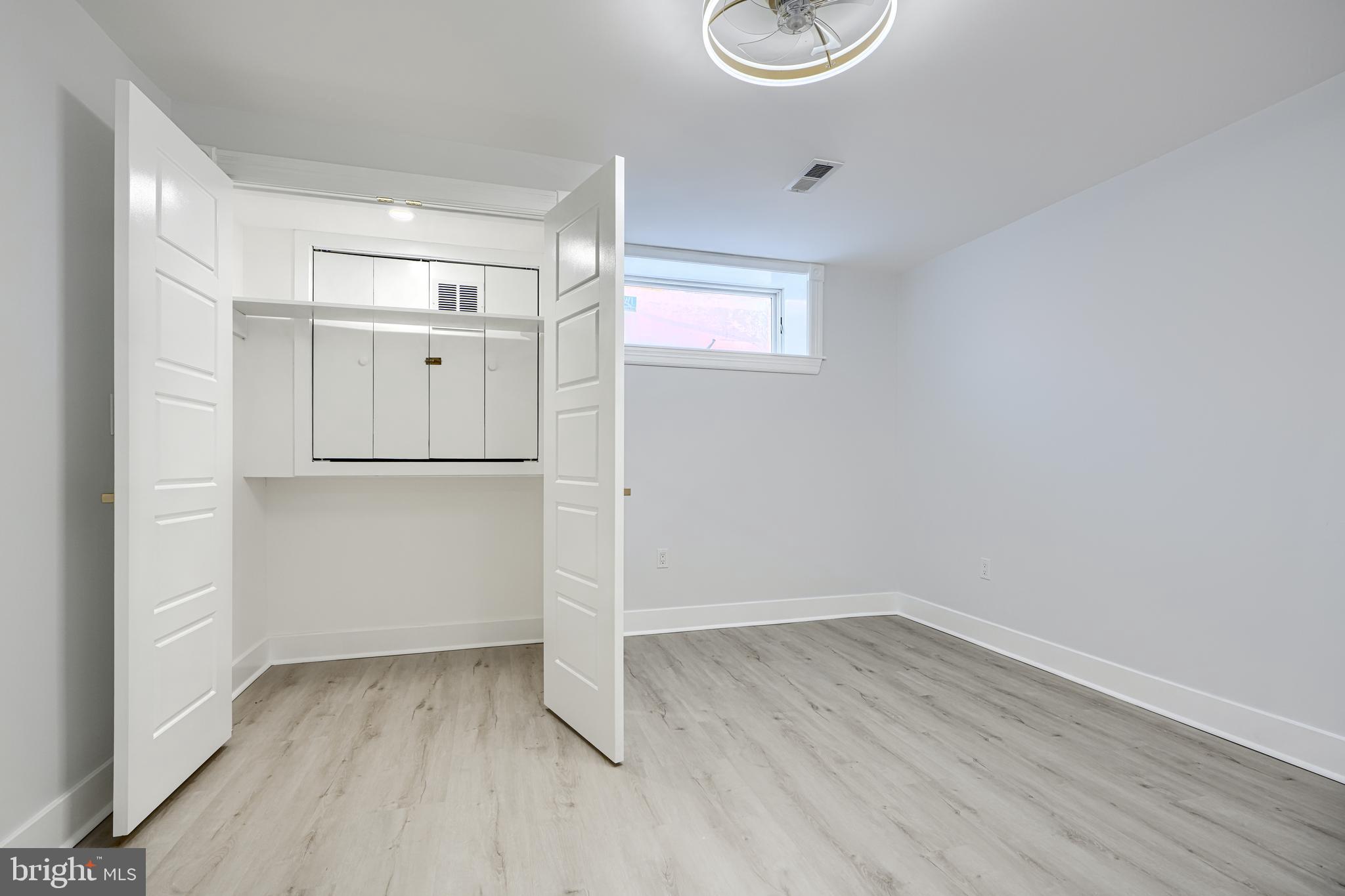 3825 Foster Avenue Baltimore, MD 21224 - Photo 42 of 54 an empty room with wooden floor and window