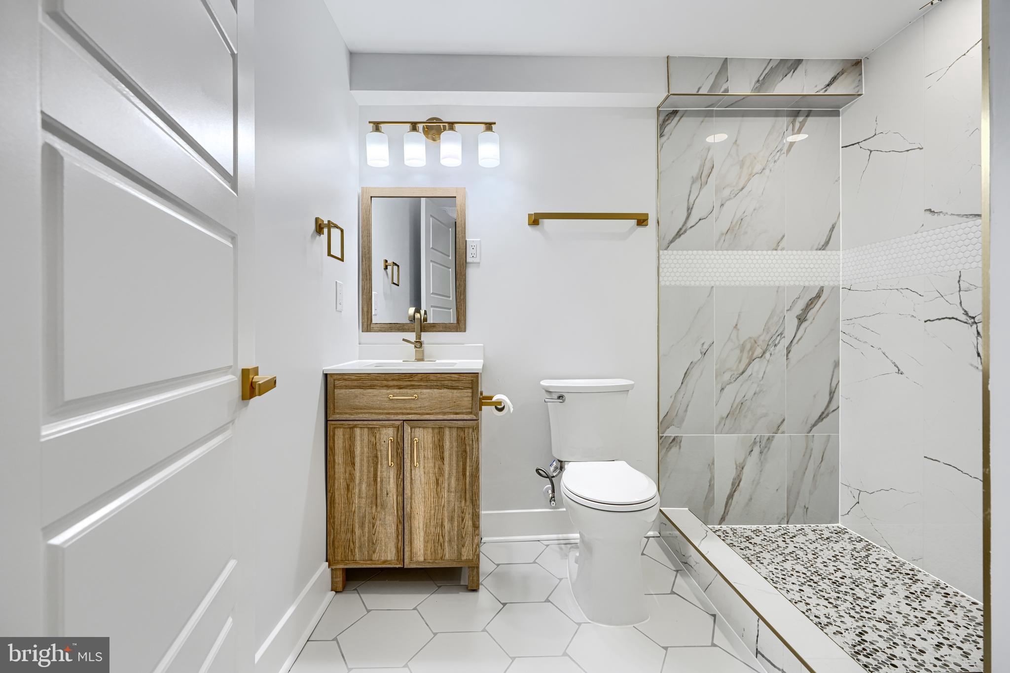 3825 Foster Avenue Baltimore, MD 21224 - Photo 44 of 54 a bathroom with a sink a toilet and shower