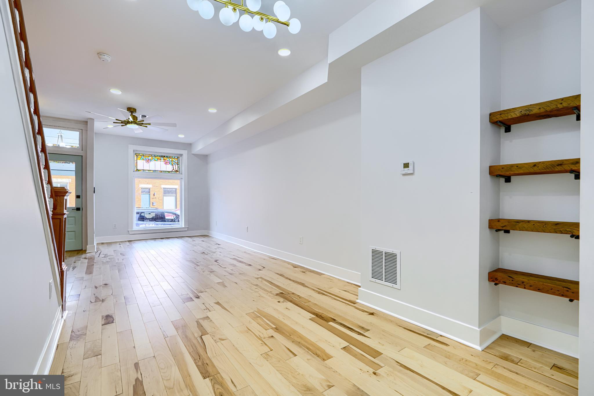 3825 Foster Avenue Baltimore, MD 21224 - Photo 5 of 54 wooden floor in an empty room with a window