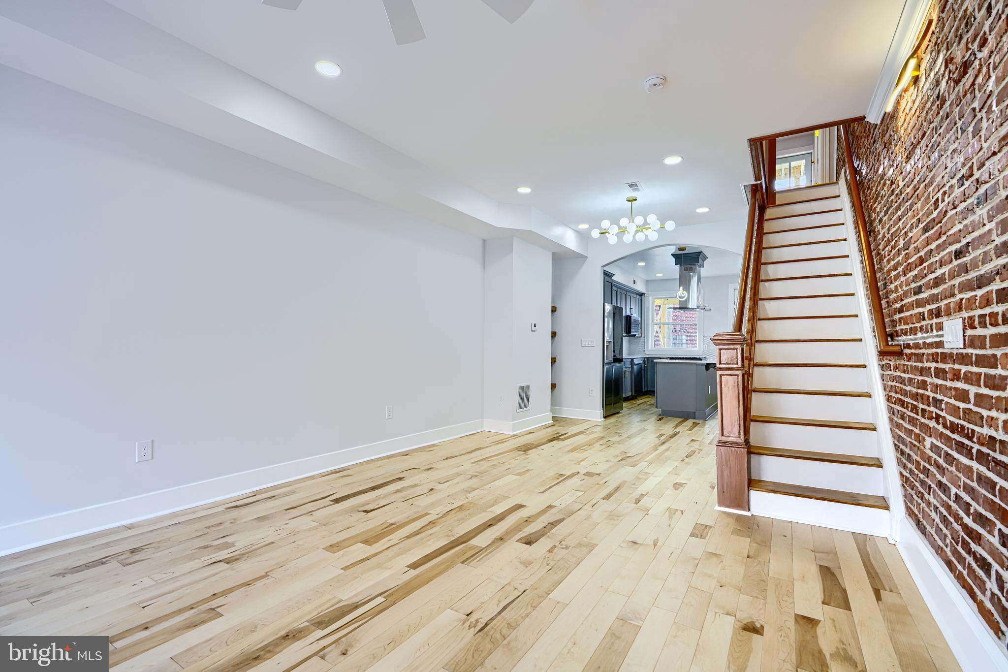 3825 Foster Avenue Baltimore, MD 21224 - Photo 9 of 54 a view of a bedroom with wooden floor and stairs