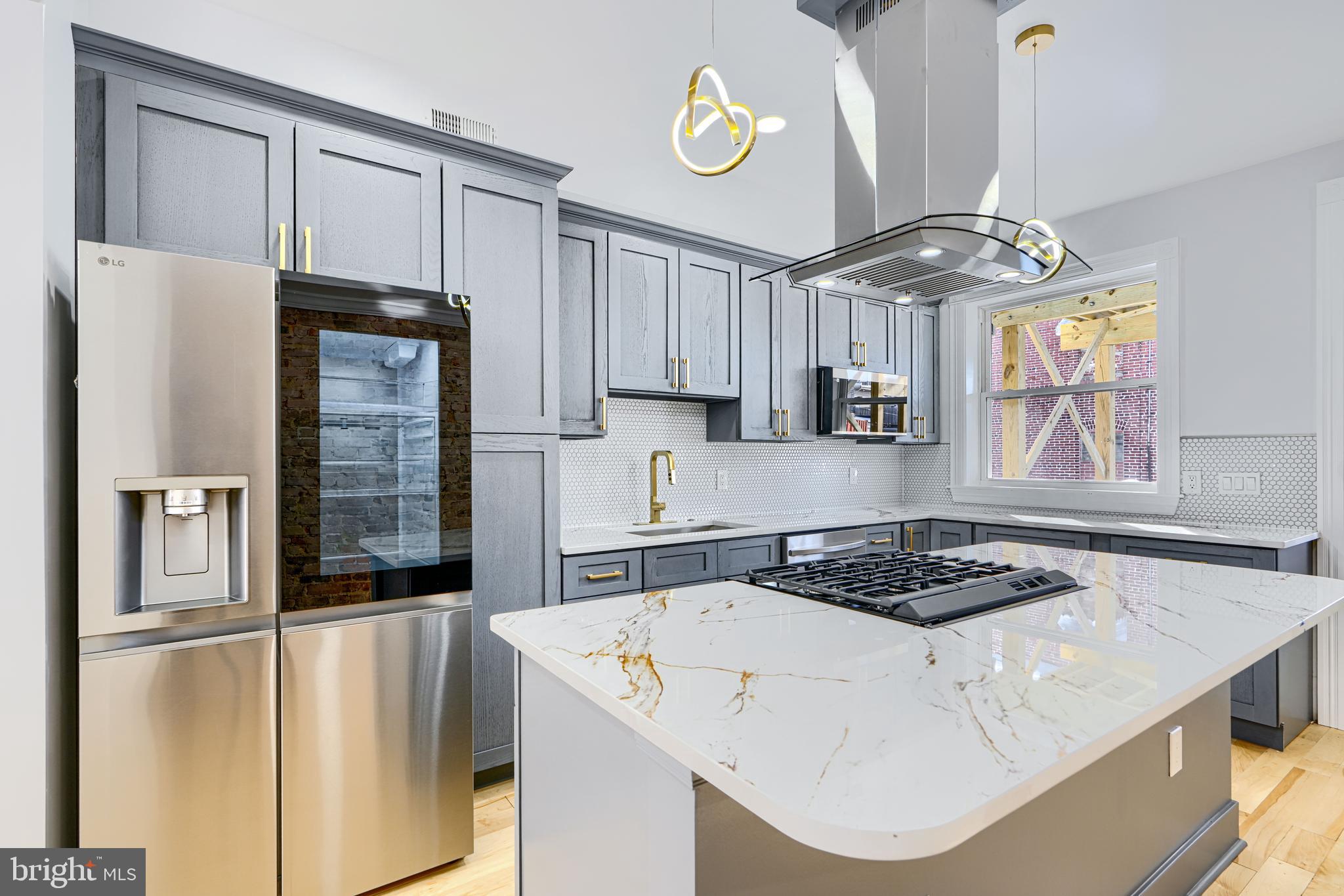 3825 Foster Avenue Baltimore, MD 21224 - Photo 10 of 54 a kitchen with stainless steel appliances granite countertop a sink a stove and refrigerator