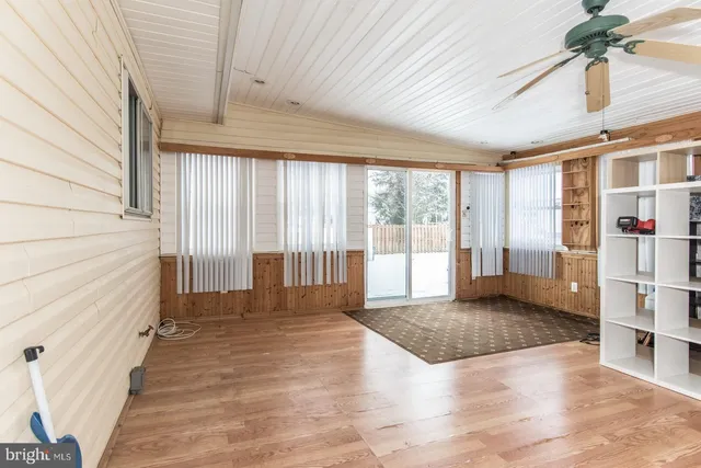 a kitchen with stainless steel appliances granite countertop a sink a stove and a wooden cabinets