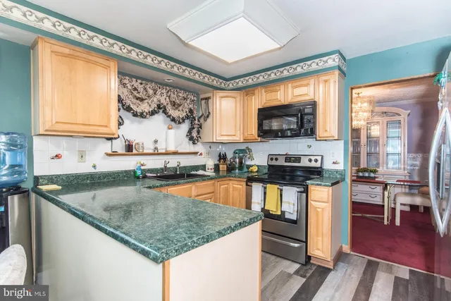 a stove top oven sitting inside of a kitchen