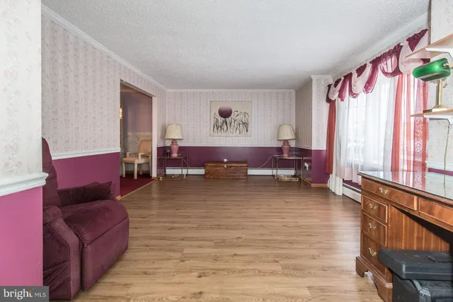 a living room with furniture a rug and a large window