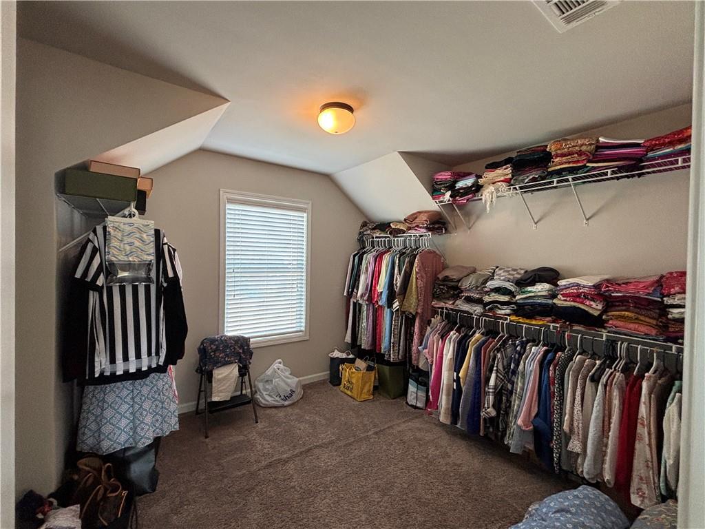 3459 In Bloom Way Auburn, GA 30011 - Photo 27 of 35 a view of walk in closet with clothes and shoes