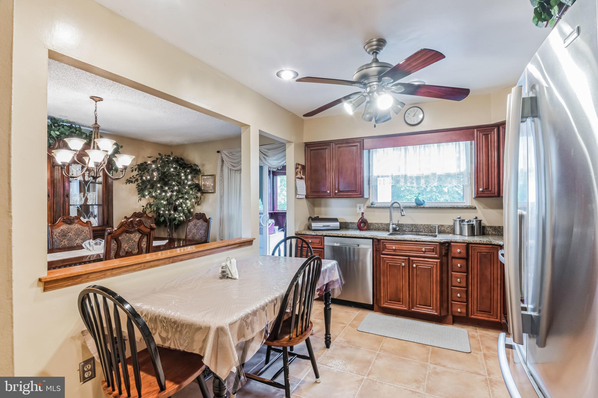 219 Forked Neck Road Shamong, NJ 08088 - Photo 11 of 26 a kitchen with stainless steel appliances granite countertop a stove top oven a refrigerator a dining table and chairs with wooden floor