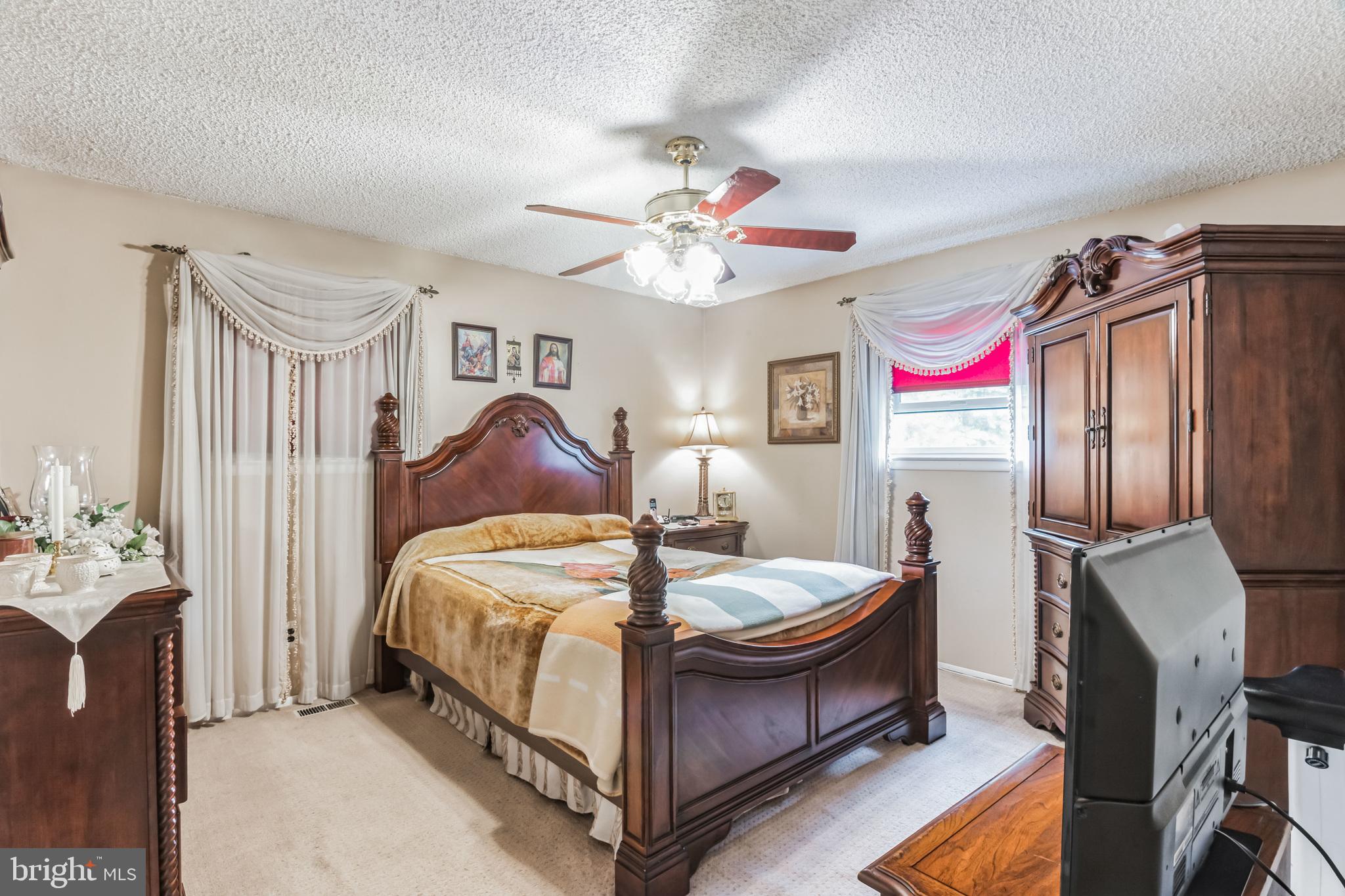 219 Forked Neck Road Shamong, NJ 08088 - Photo 16 of 26 a bed room with a bed and a chandelier