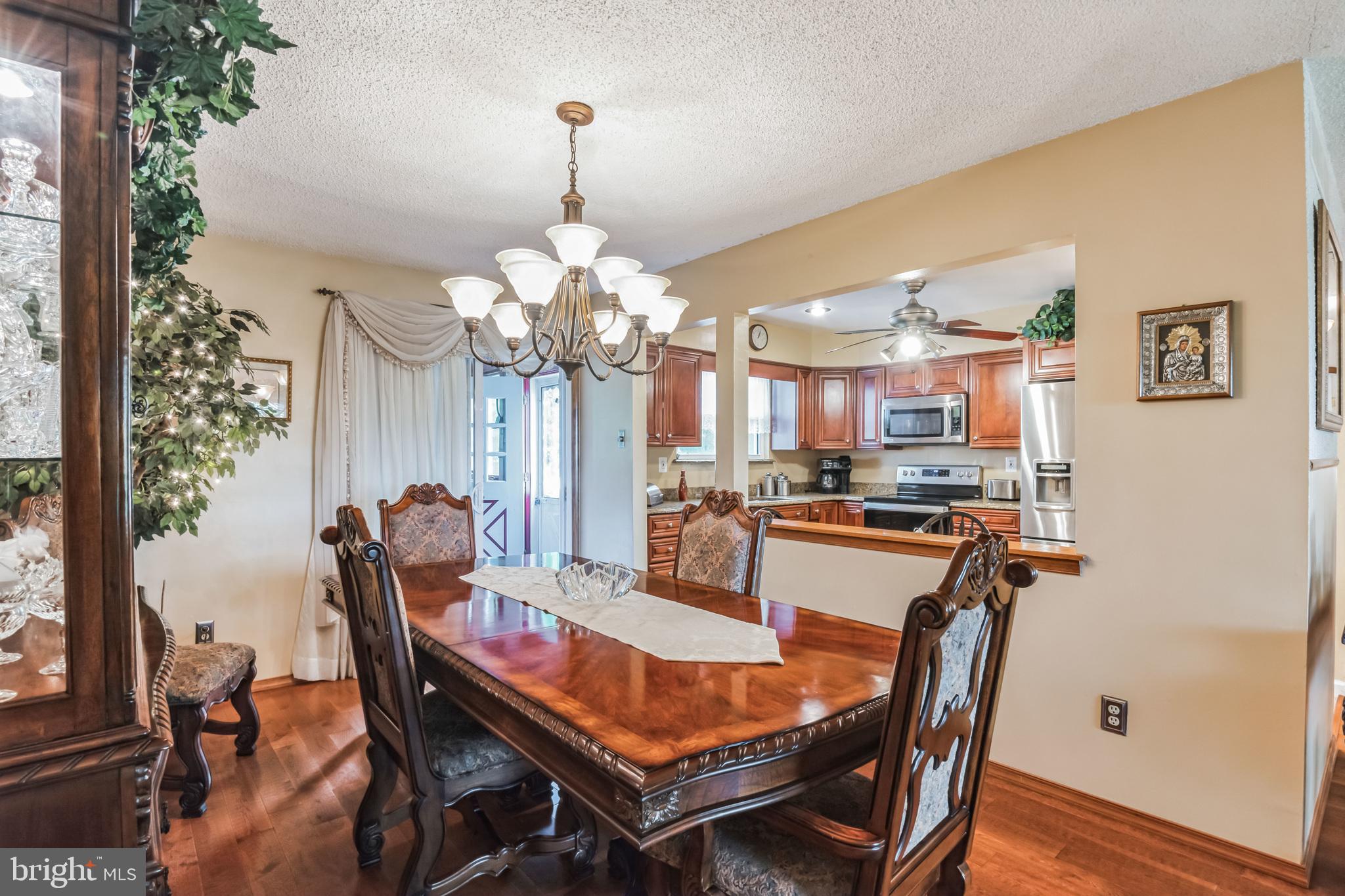 219 Forked Neck Road Shamong, NJ 08088 - Photo 7 of 26 a view of a dining room with furniture and chandelier